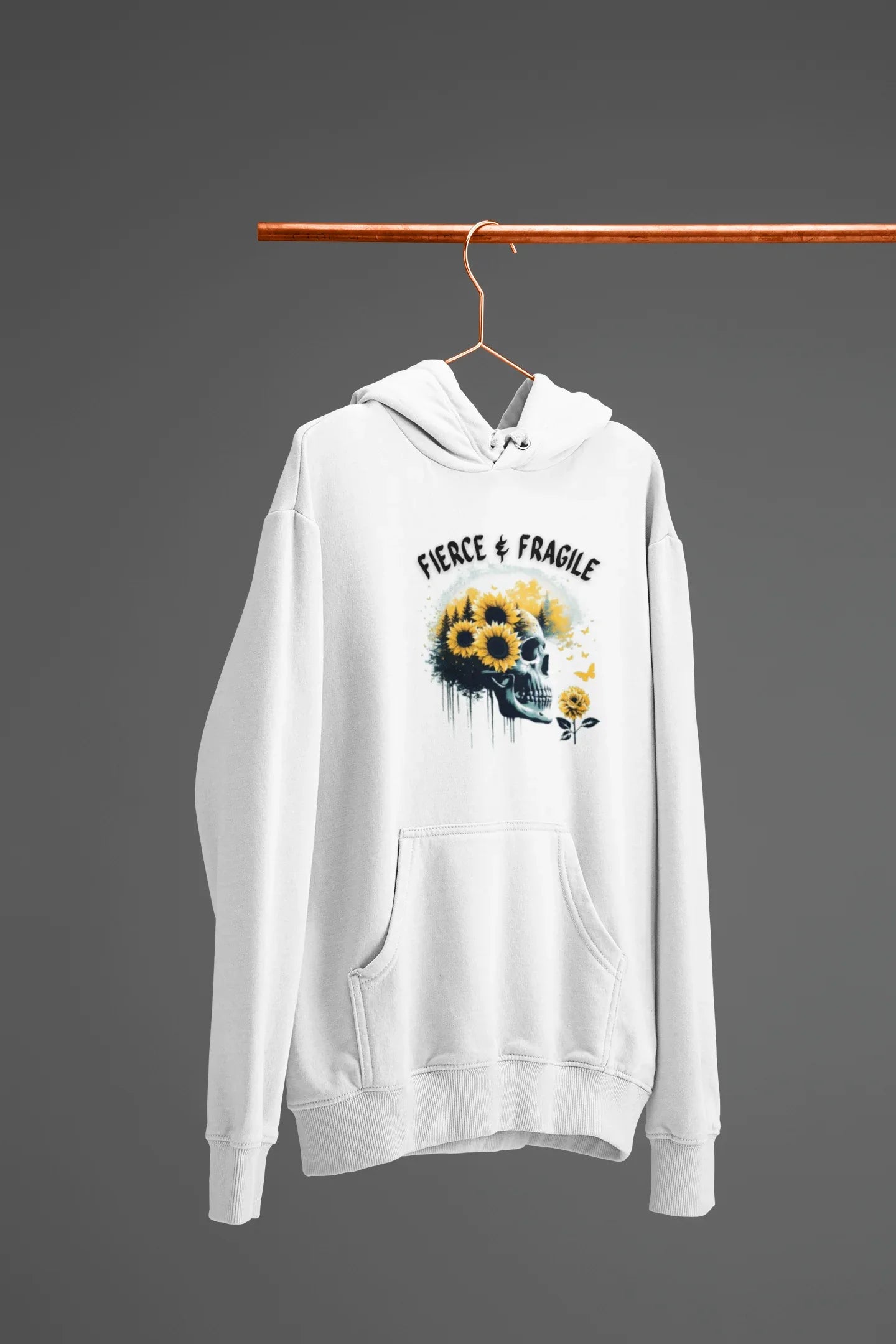White hooded sweatshirt on hanger with front graphic skull and flower design, front pouch pocket.