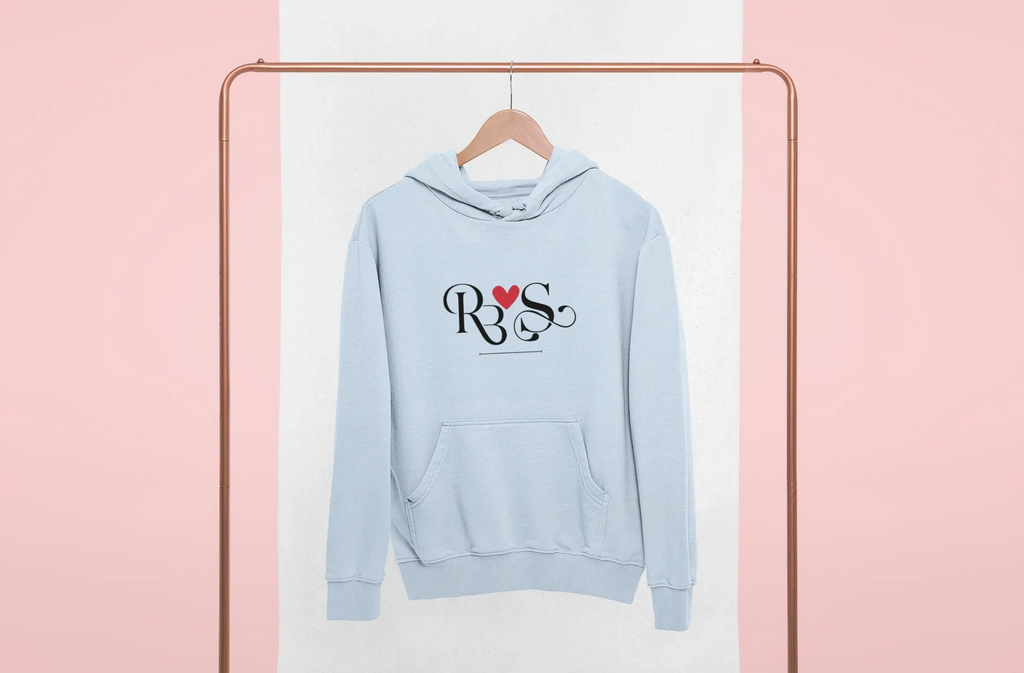 Light blue hoodie with heart monogram graphic on chest, kangaroo pocket, front view