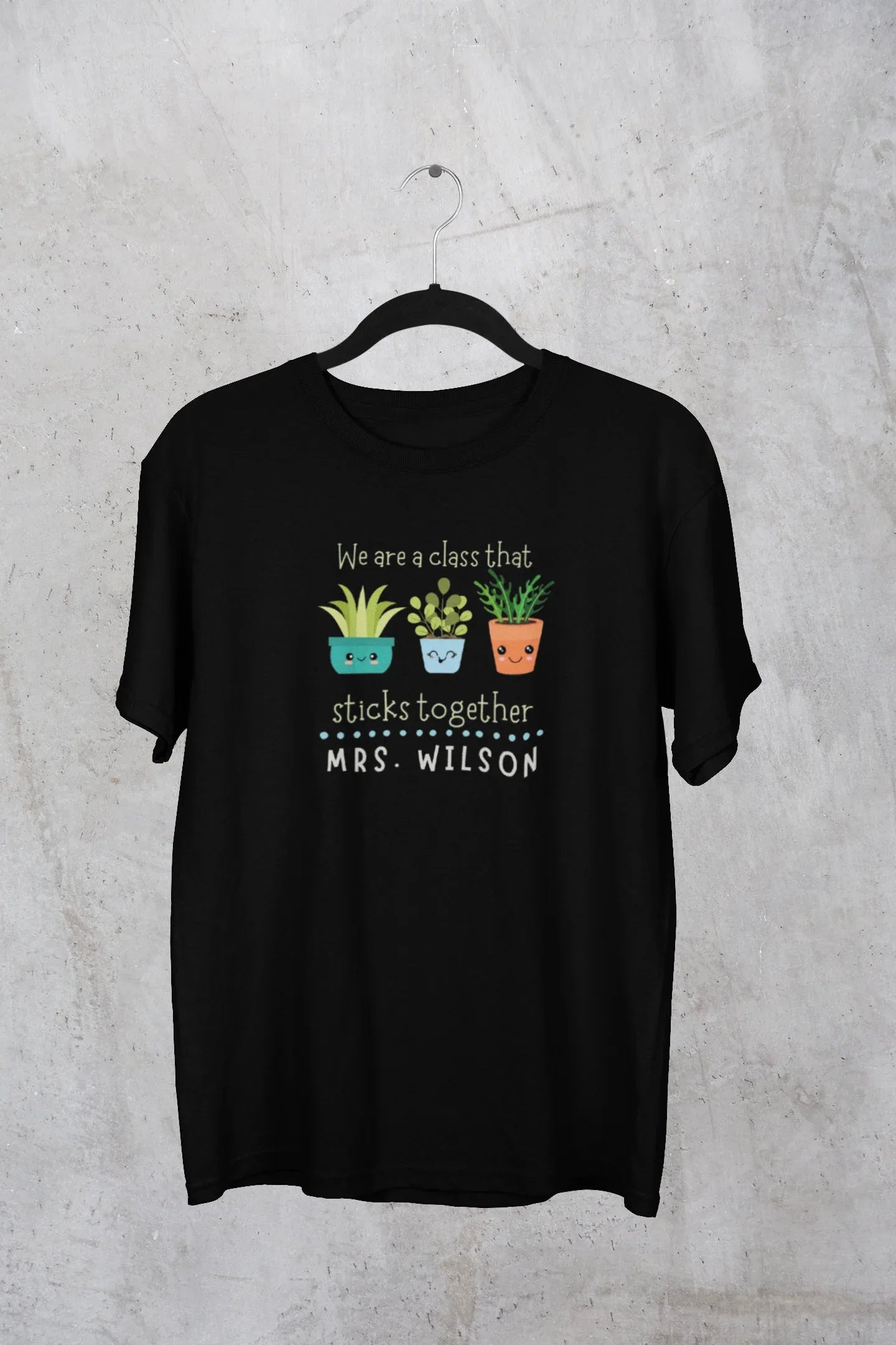 Black teacher t-shirt with cartoon plants and front “sticks together” text