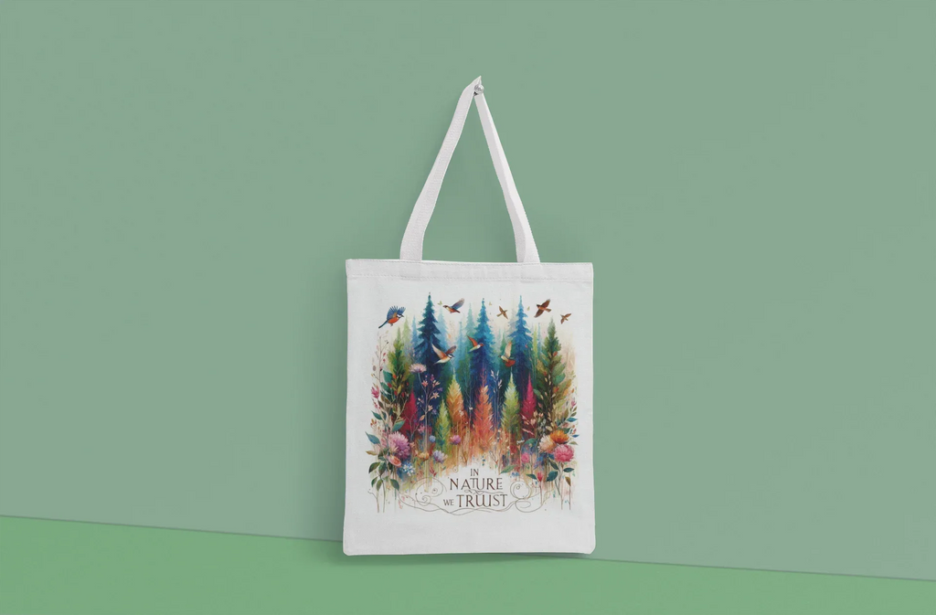 White tote bag with white handles, forest and birds graphic with Nature Trust logo