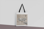 White tote bag with black straps and front print reading 'OVER THINKING EVERYTHING'