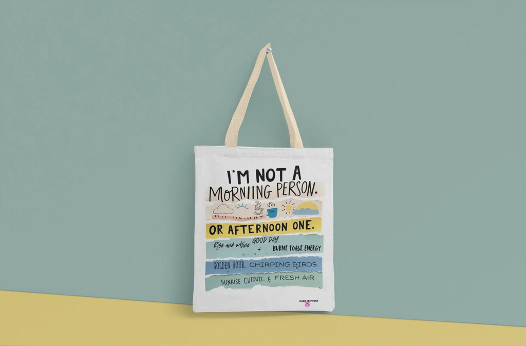 Off-white canvas tote bag with printed “morning person” text