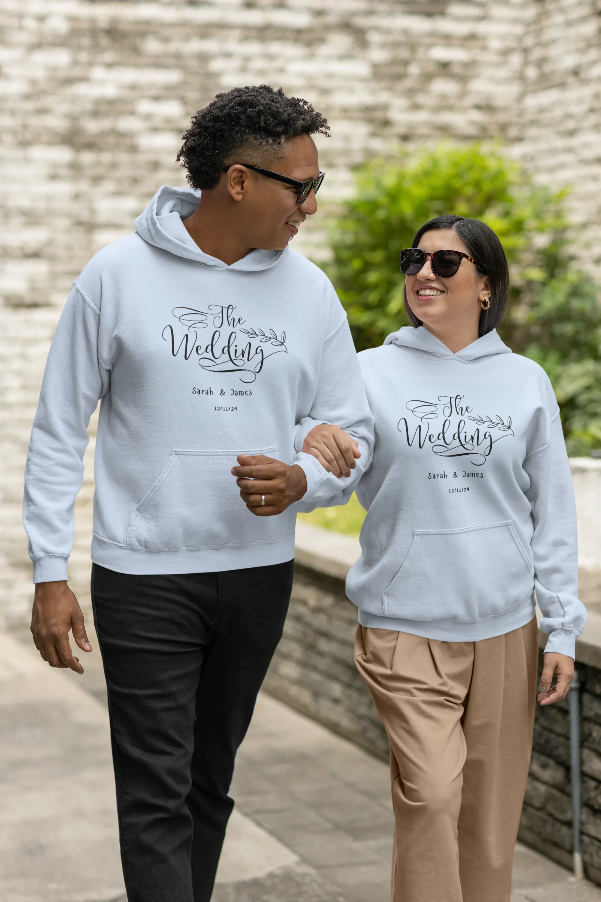 Light wedding day hoodie sweatshirt with front “The Wedding” logo print and hood