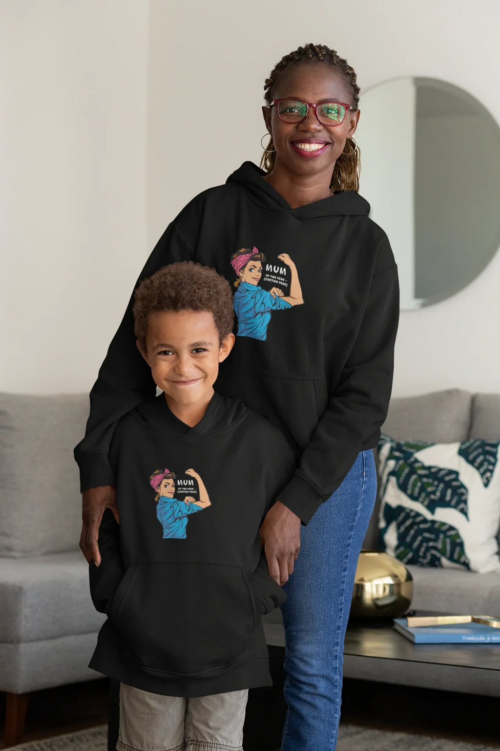 Black Mum of the Year hoodie sweatshirt worn by adult and child, front graphic visible