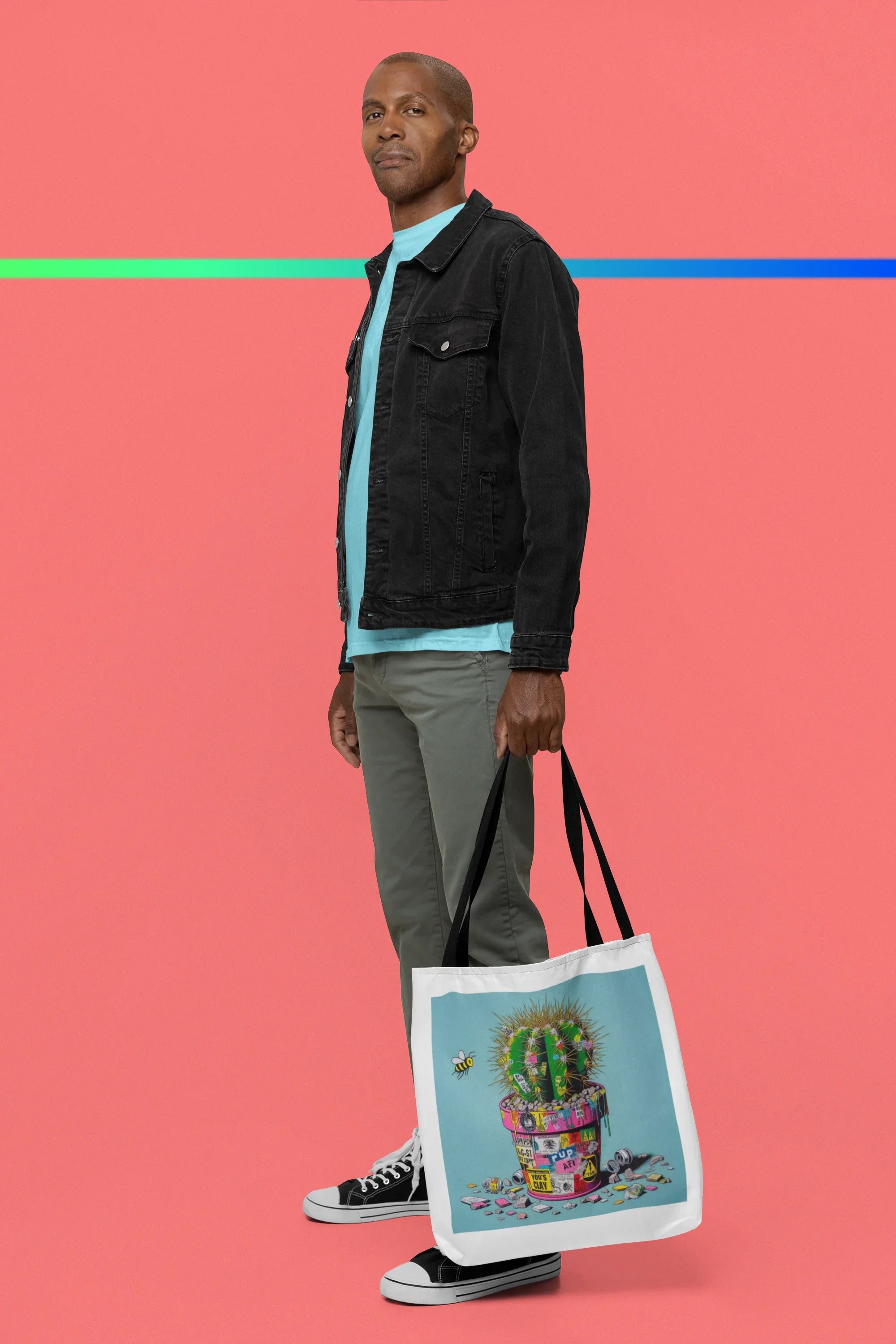 Tote bag with cactus artwork, light blue panel, black handles at side
