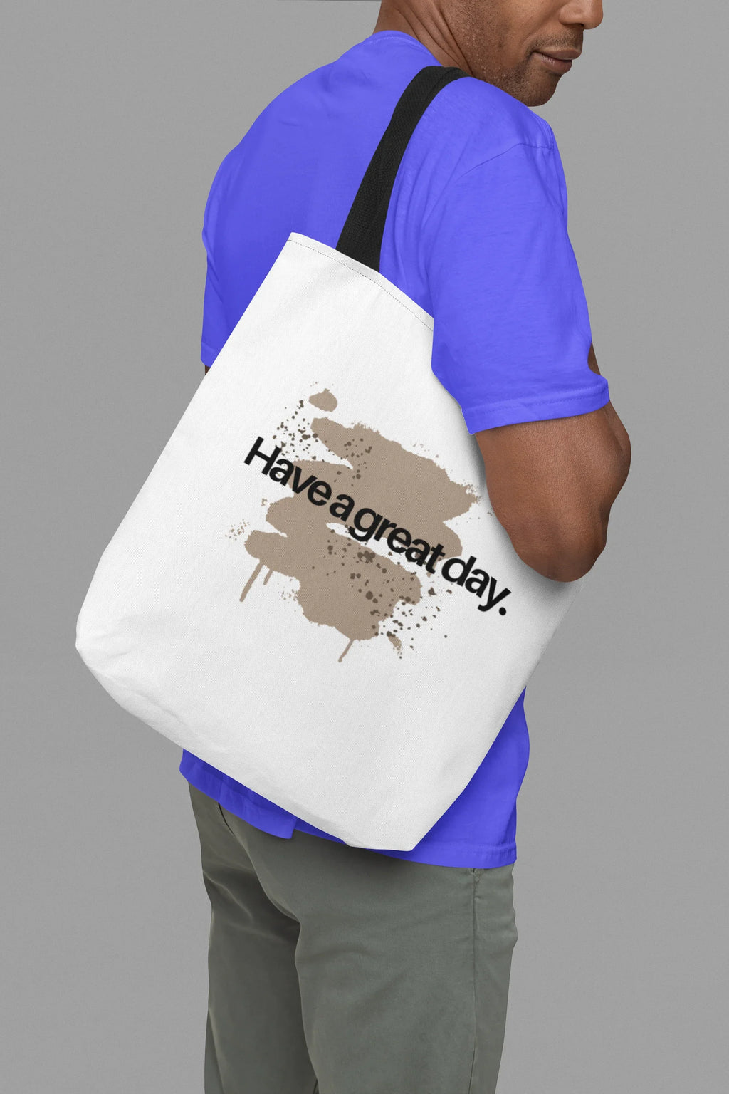 White tote bag with brown paint splatter and 'Have a great day' message on front