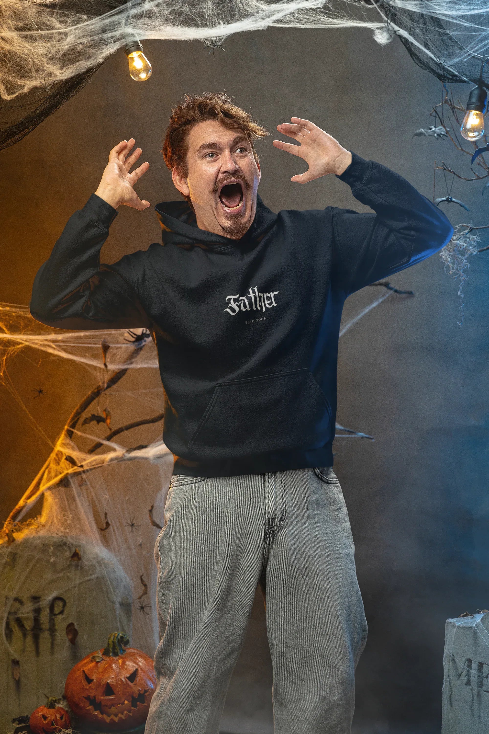 Man wearing a dark navy pullover hoodie with front pocket and hood drawstrings.