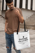 White canvas tote bag with black top handles and printed slogan on the front