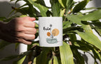 White ceramic mug held in hand, with Evie name and floral swirl design on front.