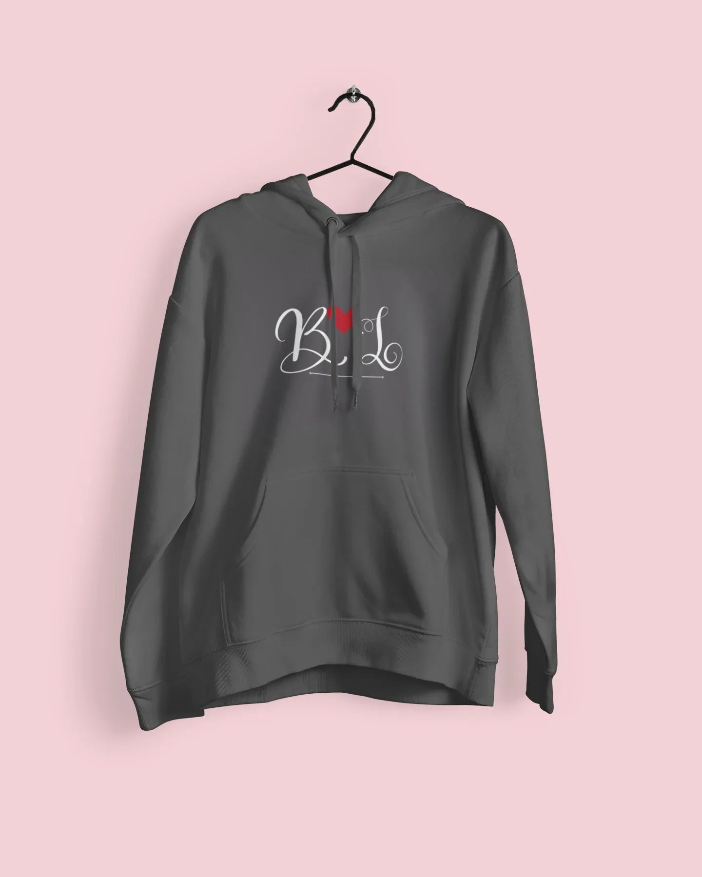 Charcoal hoodie with heart monogram graphic and small red accent, hanging view