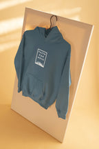 Light blue hoodie sweatshirt on hanger, folded over with hood and front faith graphic