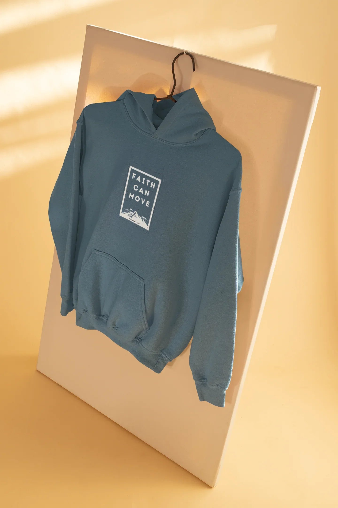 Light blue hoodie sweatshirt on hanger, folded over with hood and front faith graphic