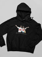 Black zip-less hoodie with drawstring and couple heart graphic on front.
