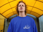 Royal blue sweatshirt with a white snail graphic on the front chest.