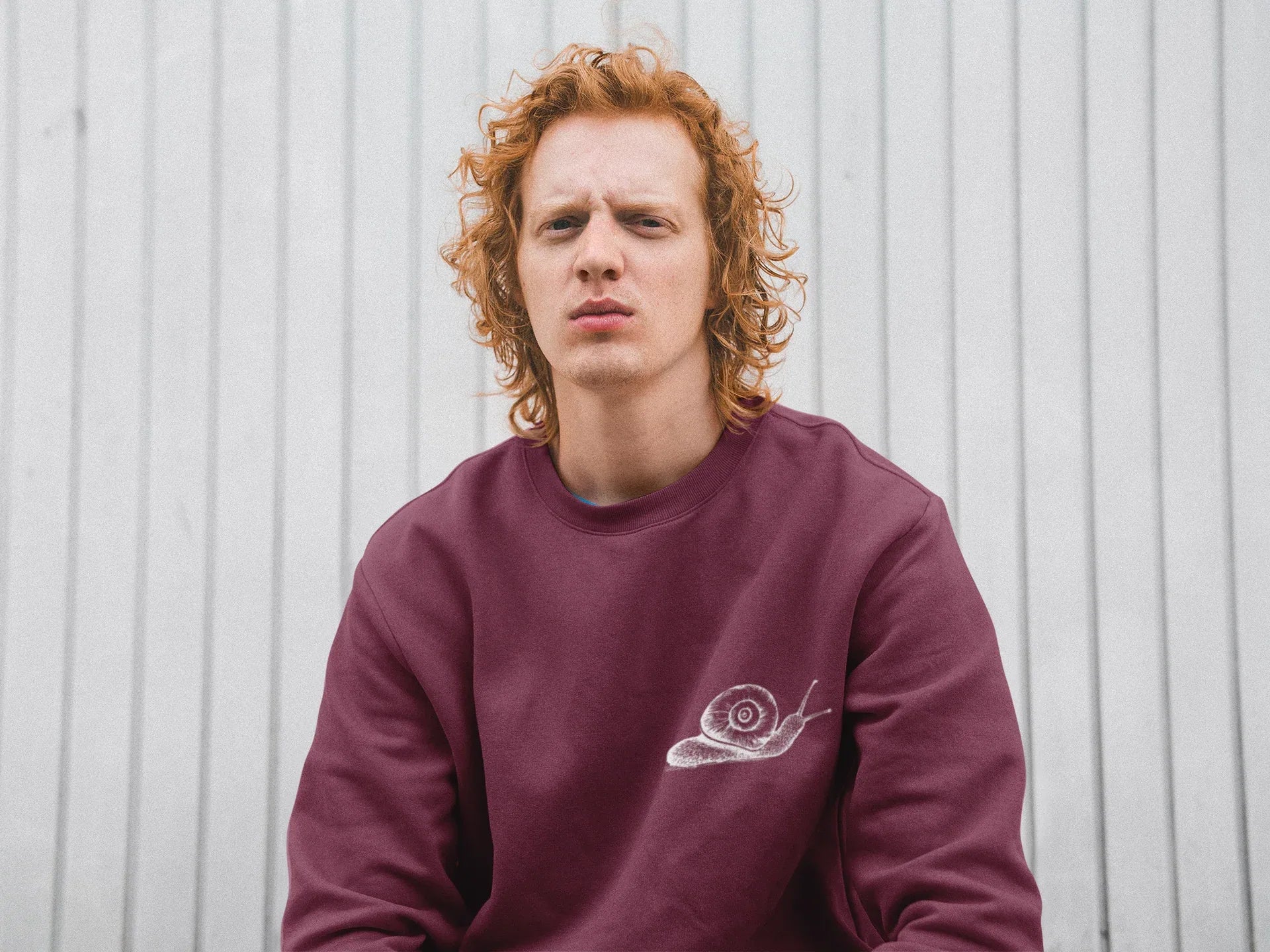 Burgundy sweatshirt with a white snail graphic on the front chest.