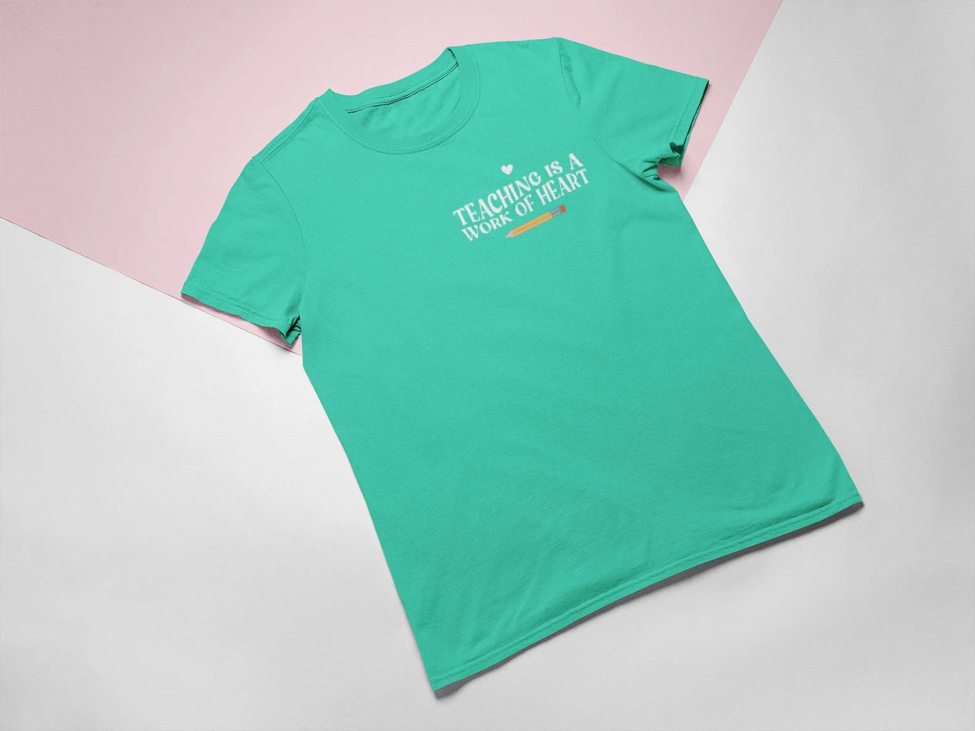 Teal unisex T-shirt with crew neck and “Teaching is a Work of Heart” chest print