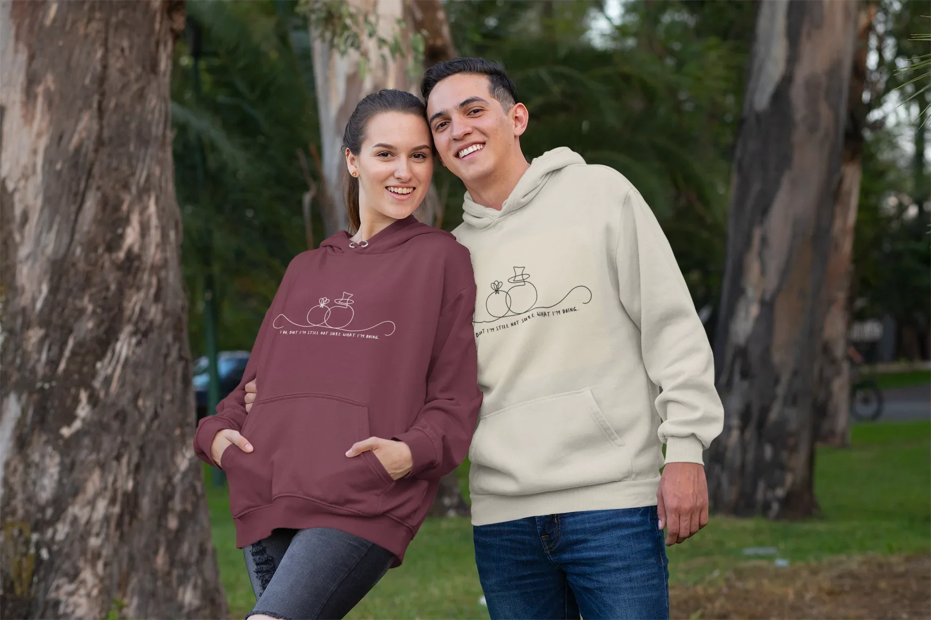 Maroon and cream unisex hoodies worn by two people, front line-art wedding graphic
