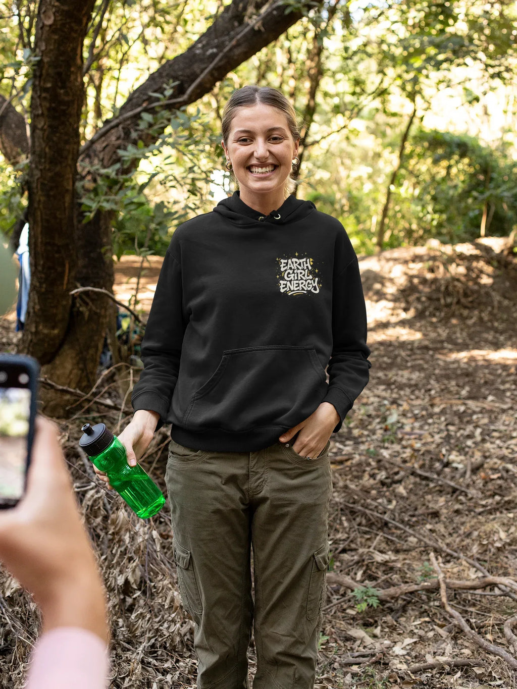 Black hoodie with drawstring hood, front pouch pocket, and "Earth Girl Energy" chest logo.