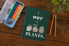 A5 spiral notebook with green cover and “I wet my plants” typography plus succulent pot illustrations.