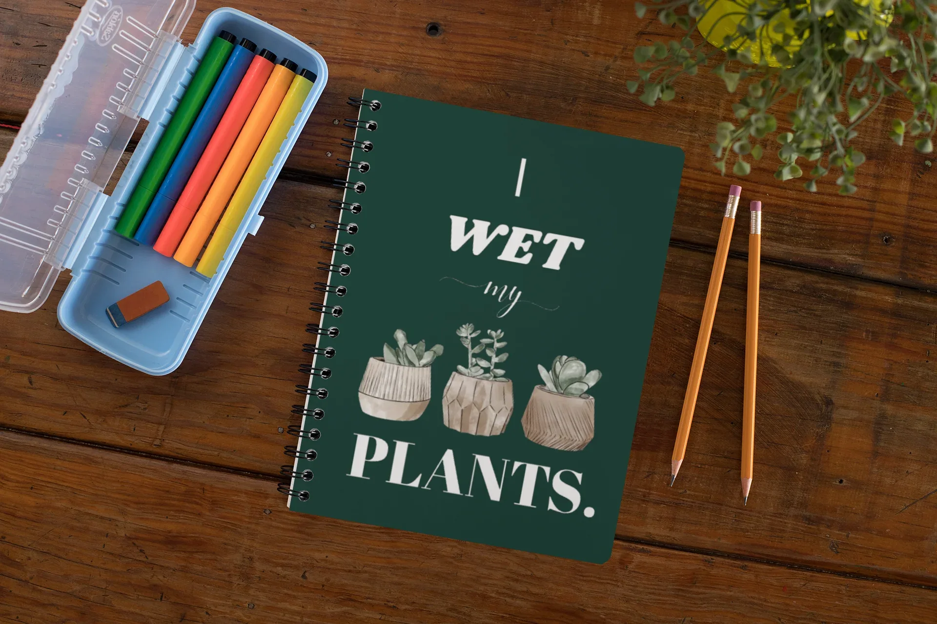 A5 spiral notebook with green cover and “I wet my plants” typography plus succulent pot illustrations.