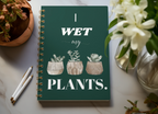 A5 spiral notebook, dark teal cover with “I wet my plants” text and succulent pot artwork.