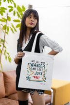 White canvas tote bag with long black handles, colorful front print held in hands
