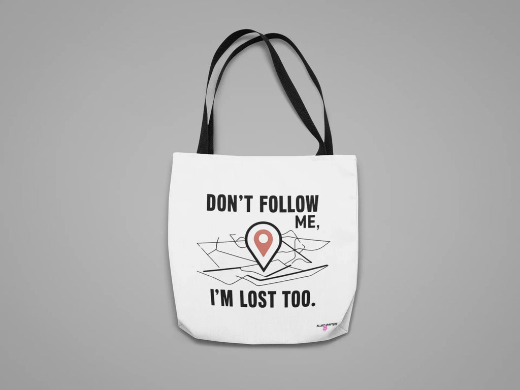 White canvas tote bag with black text "DON'T FOLLOW ME" and red location-pin illustration