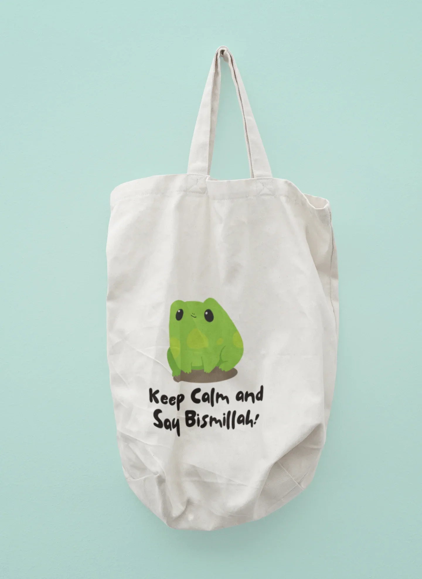 White cotton tote bag with frog graphic and slogan “Keep Calm and Say Bismillah!”