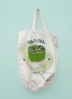 Off-white tote bag with 'MATCHA' print and green matcha drink graphic, stars