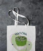White tote bag with “MATCHA” graphic and wide white straps