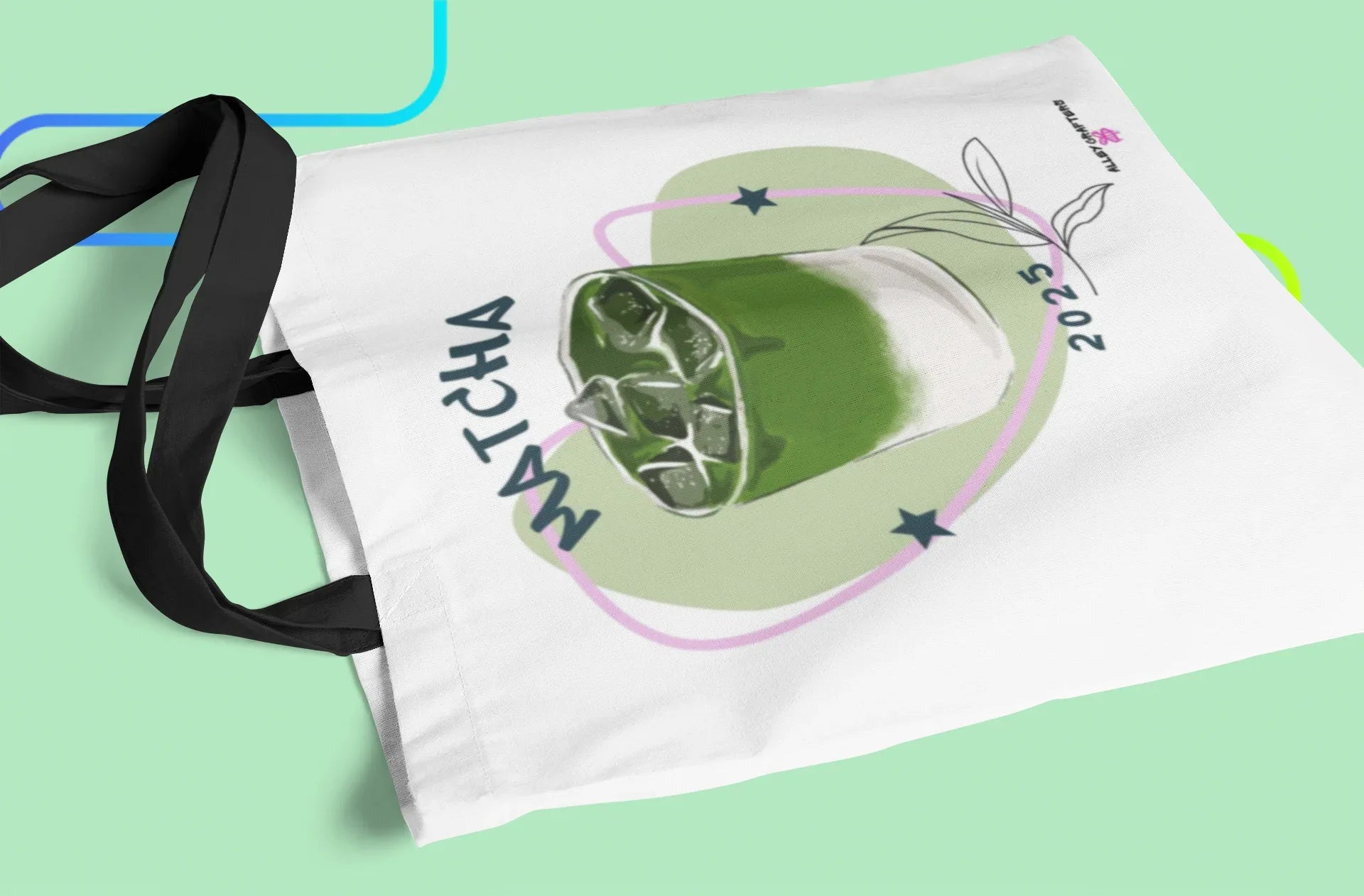 White tote bag with matcha drink graphic and long black carrying strap
