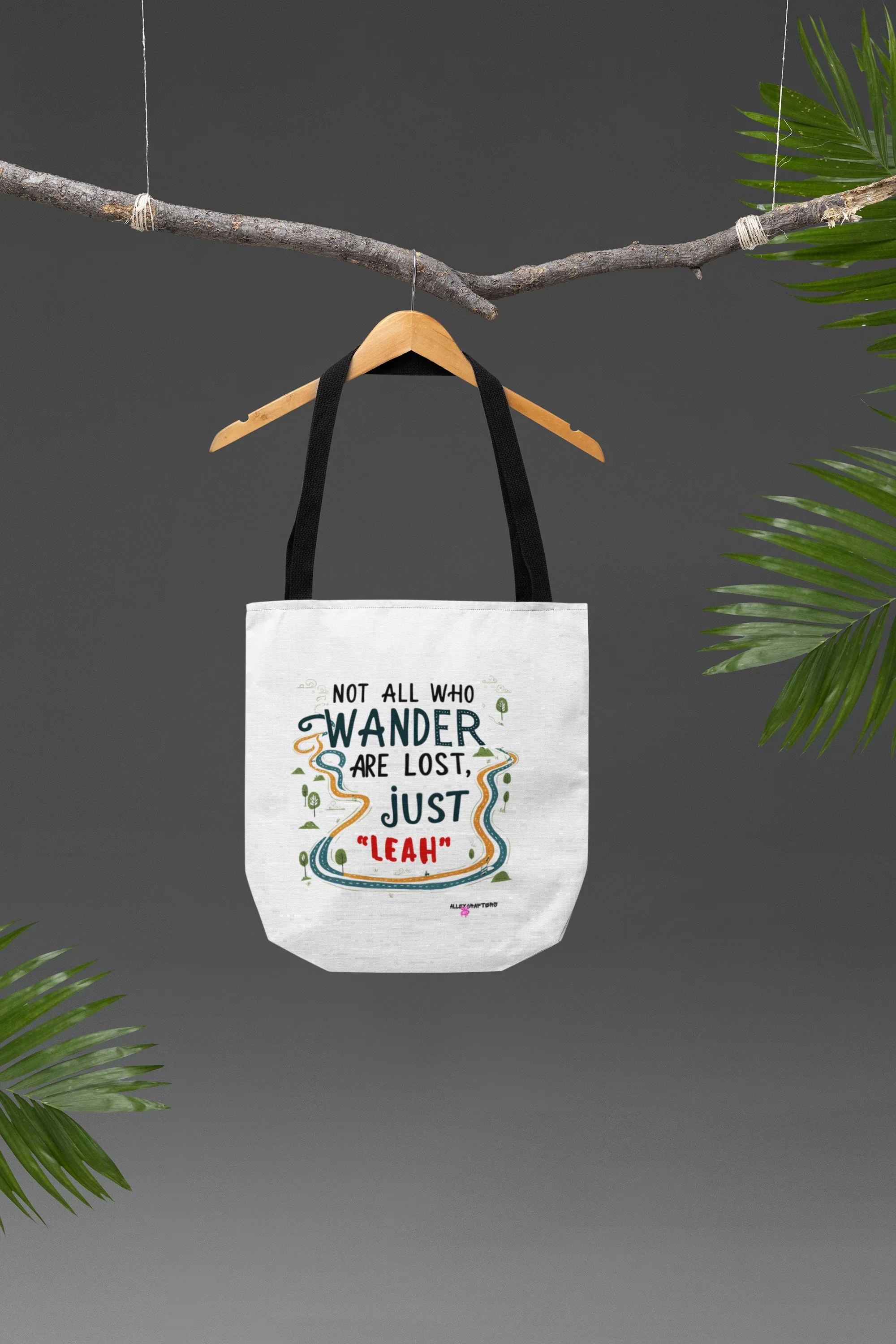 White canvas tote bag with short top handles and colorful front quote graphic