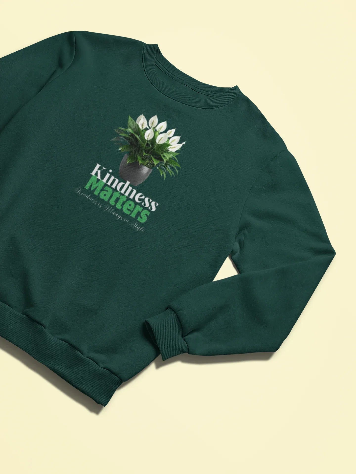Forest green crewneck sweatshirt with tree graphic and 'Kindness Matters' text