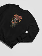 Black crewneck sweatshirt with small floral graphic and inspirational text on chest