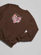 Dark brown sweatshirt with “BIRTHDAY GIRL” text and floral heart graphic