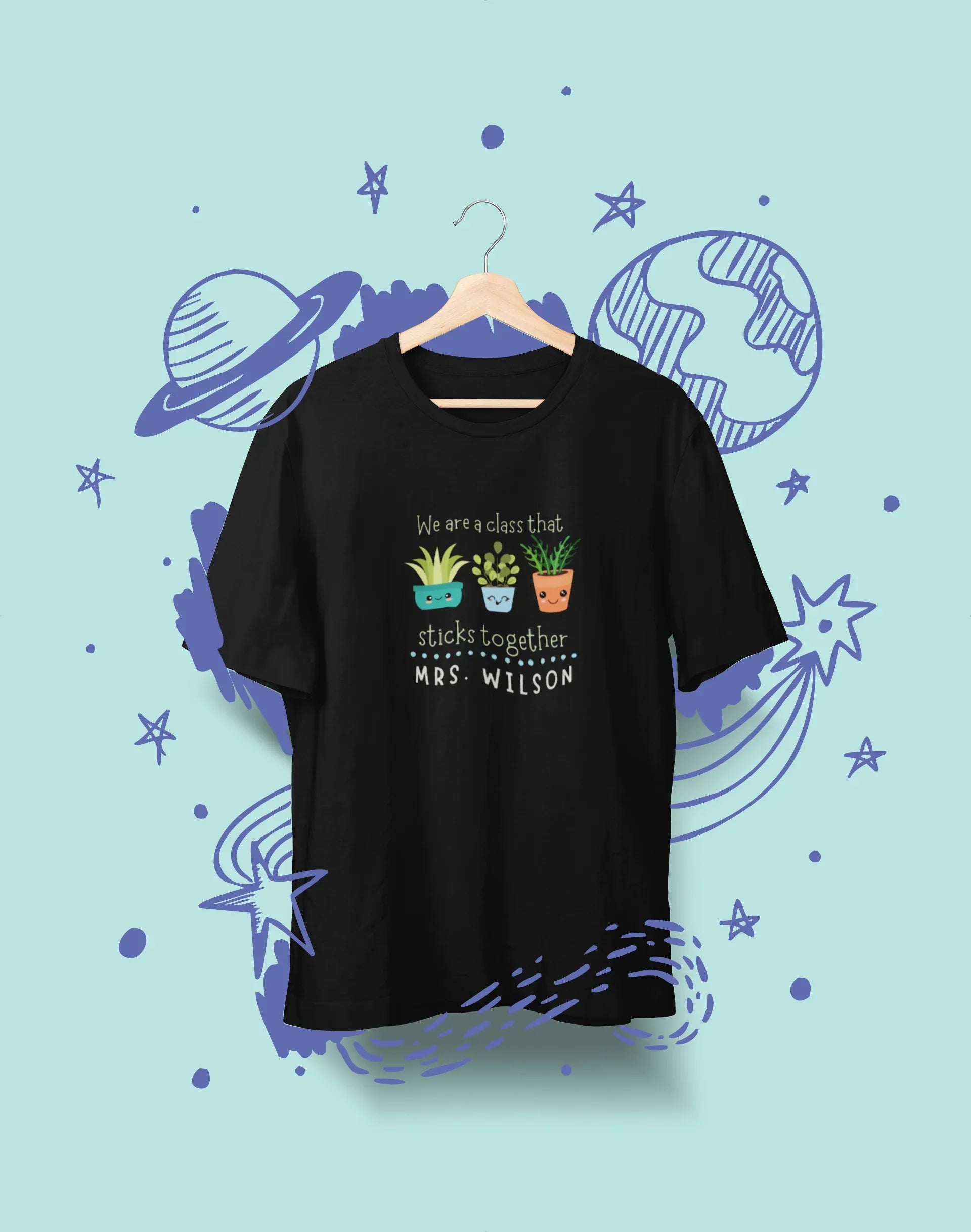 Black crewneck T-shirt with cartoon classroom icons and 'MRS. WILSON' lettering.