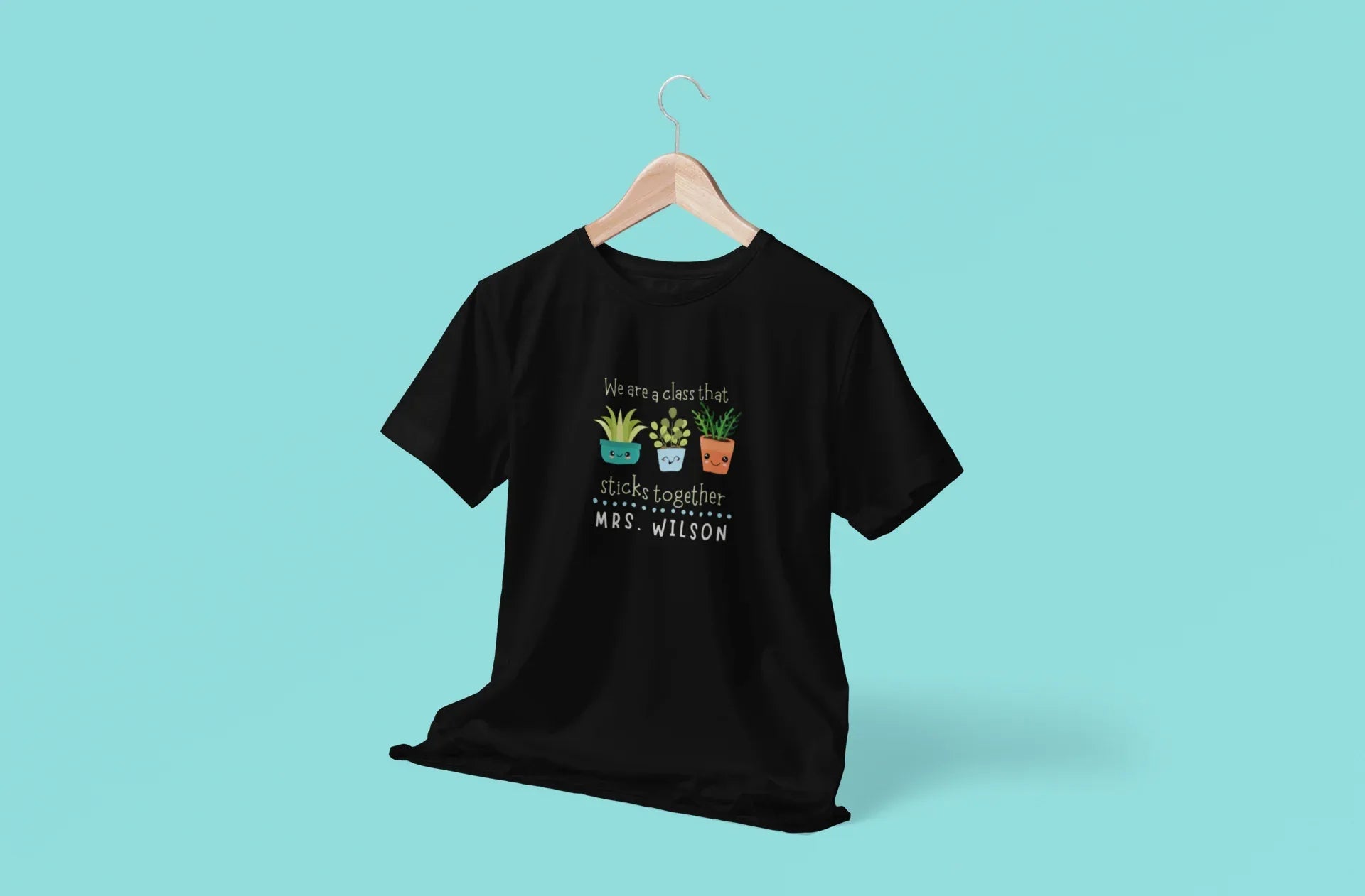 Black teacher t-shirt with centered cartoon plant graphic and front text