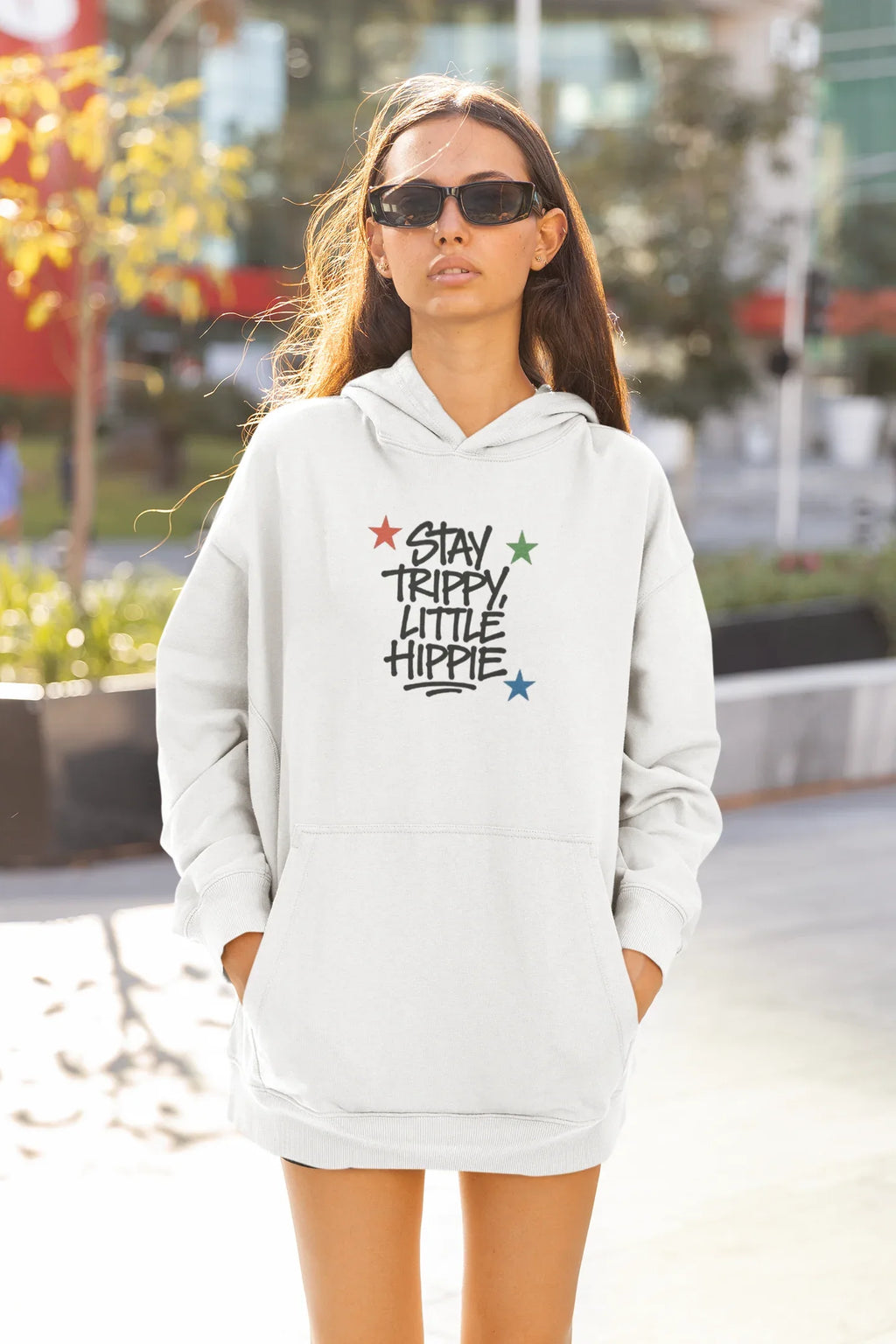 White hoodie with front "Stay Trippy Little Hippie" star text graphic