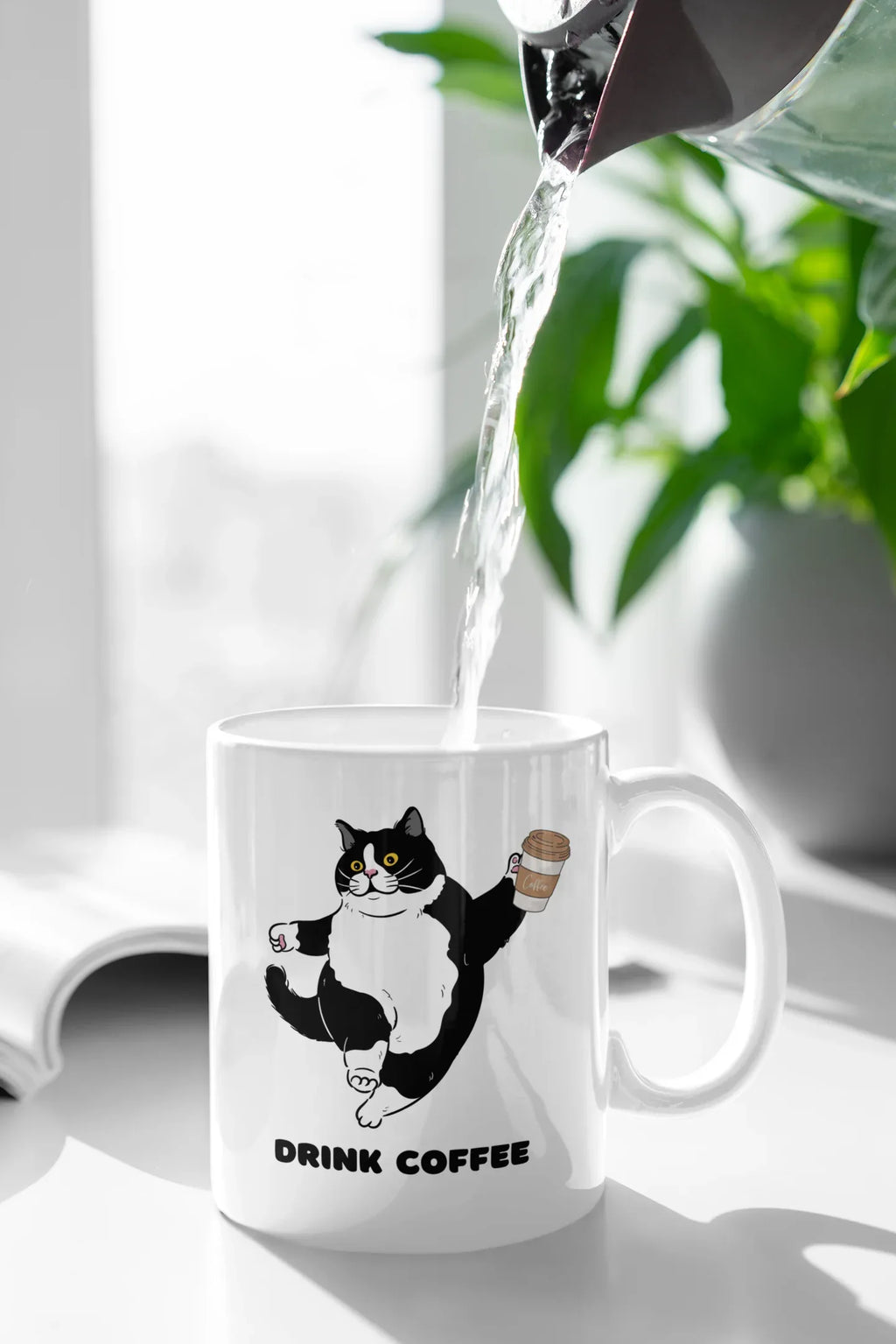 White coffee mug with cat graphic and 'DRINK COFFEE' text on front.