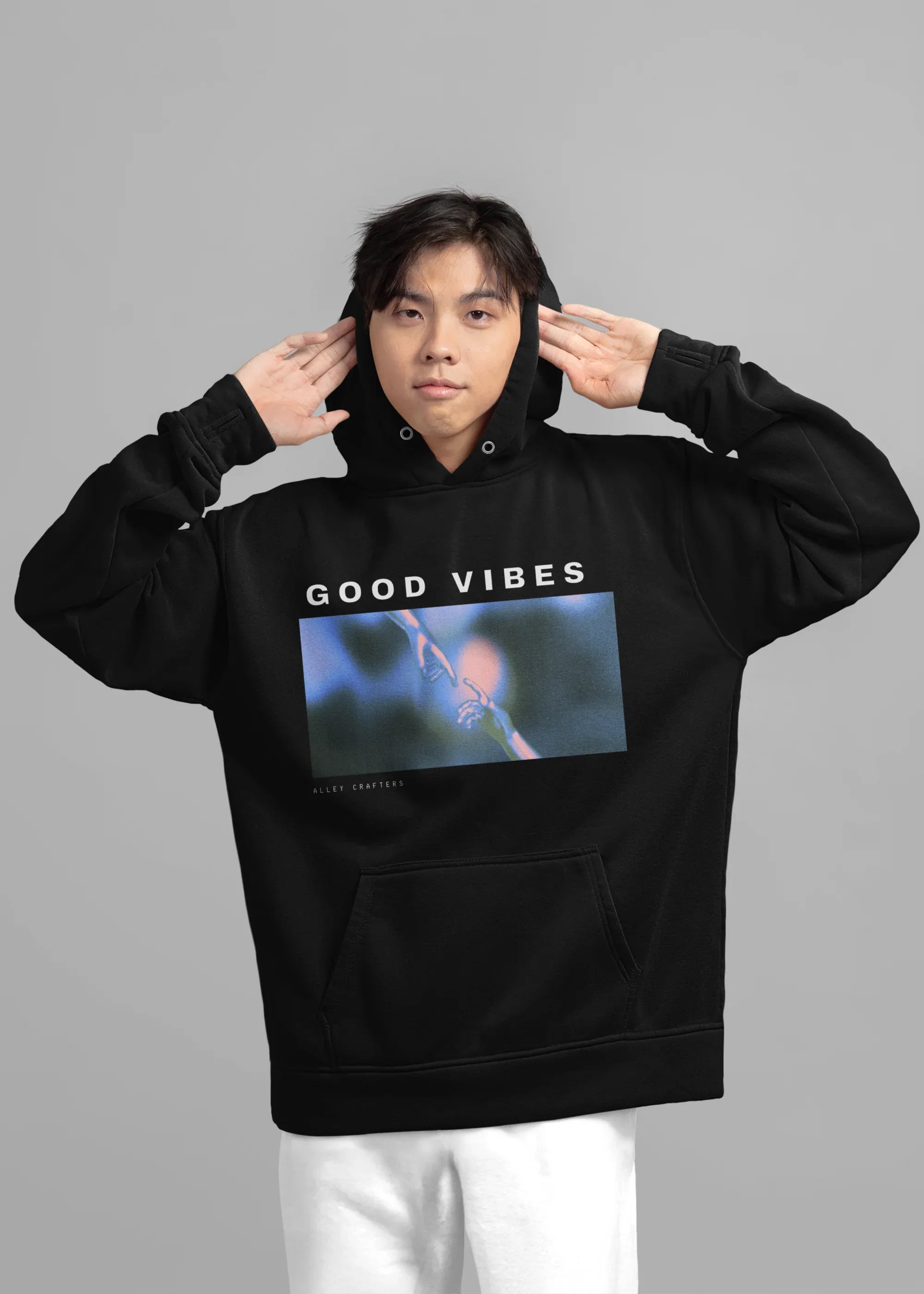 Black unisex hoodie worn, 'GOOD VIBES' front graphic and kangaroo pocket