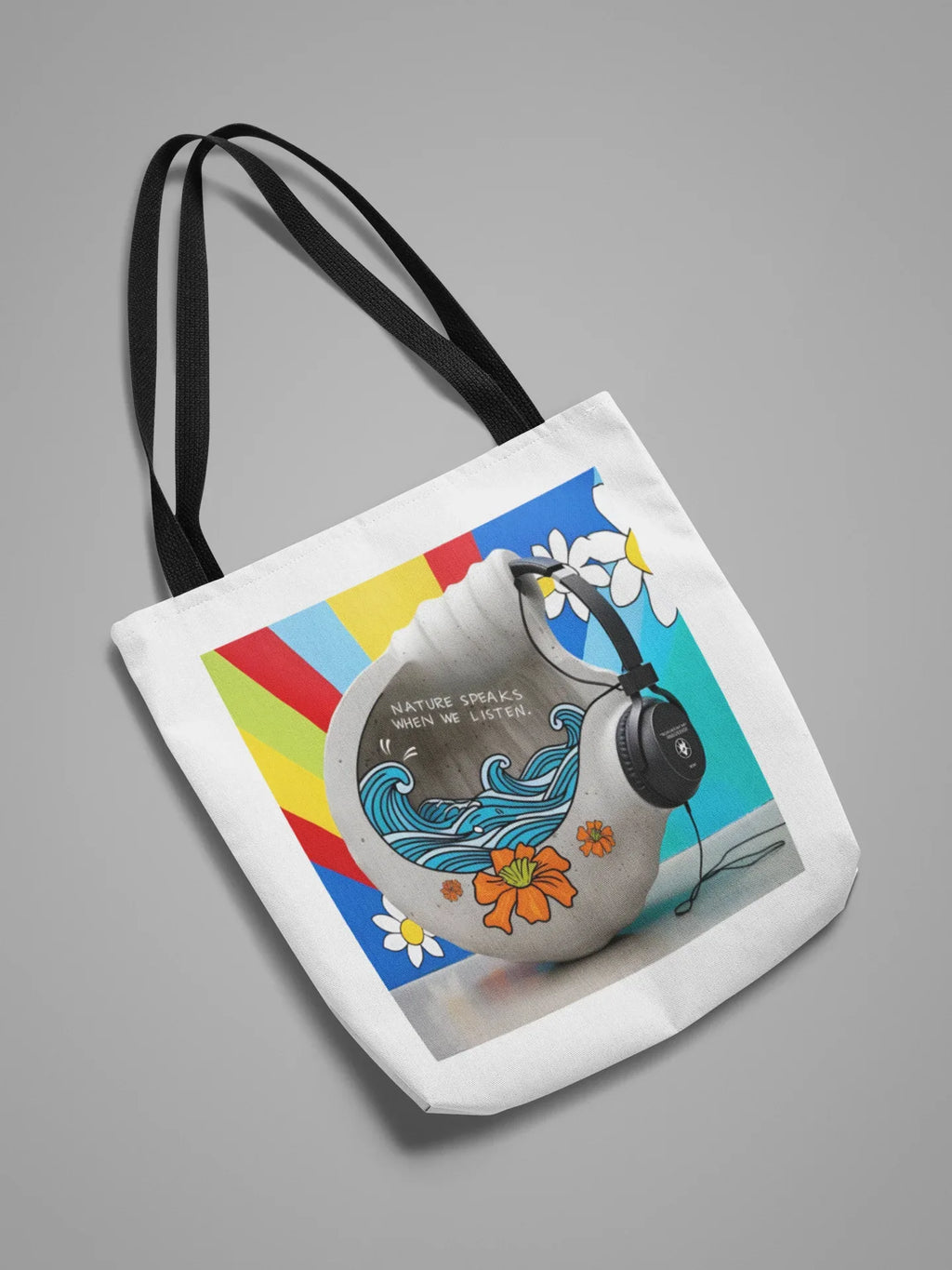 White tote bag with nature-themed headphones graphic, angled view, black shoulder straps