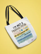 White tote bag with black handles and colorful 'I'm not a morning person' text