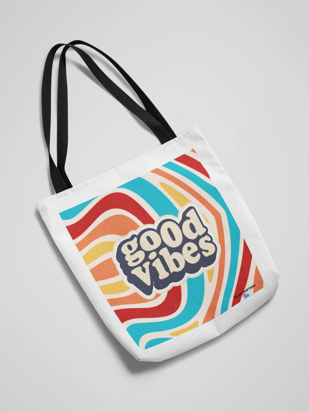 White tote bag with “good vibes” print and black top handles