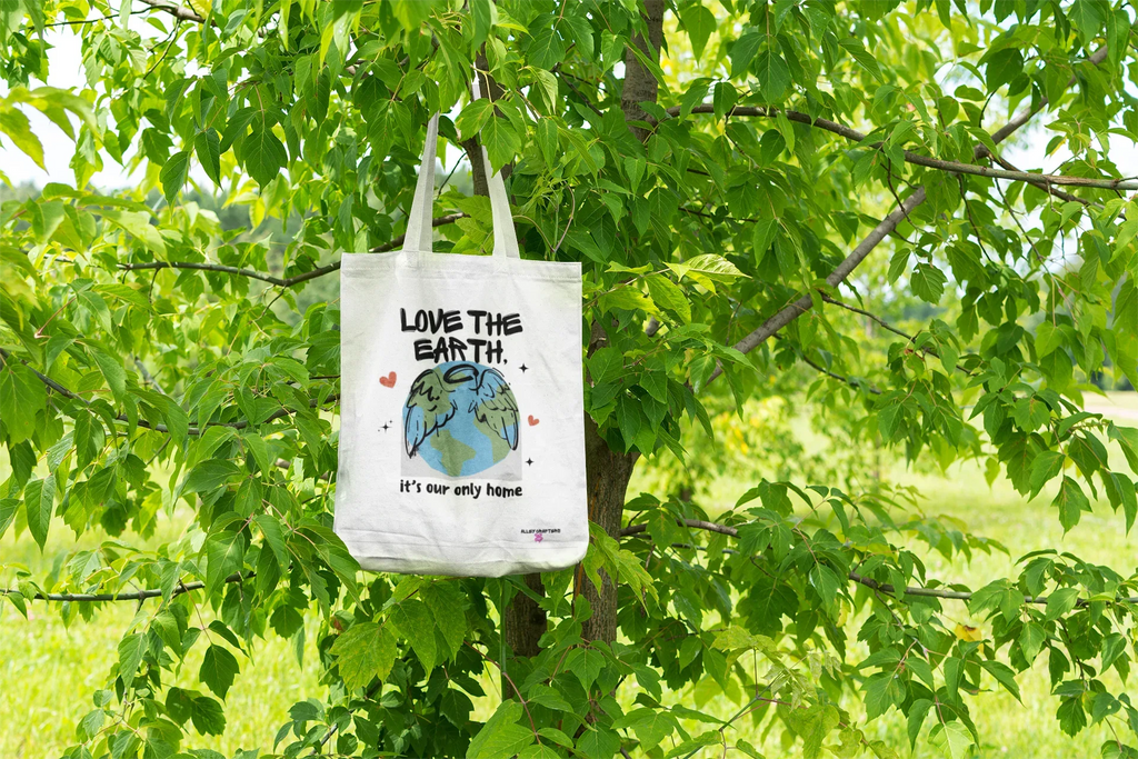 White tote bag with Earth graphic and text Love the Earth, it’s our only home