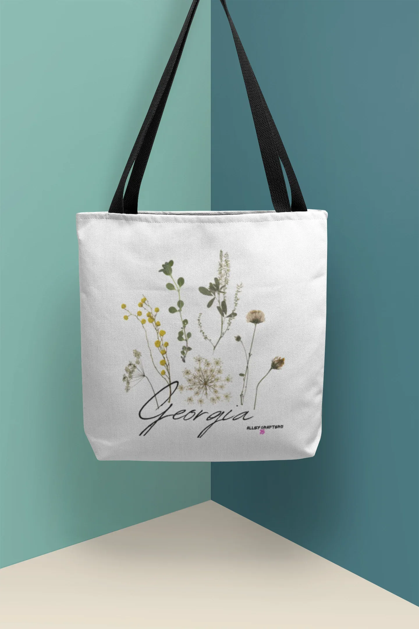 White tote bag with botanical wildflower print and cursive word, top handles