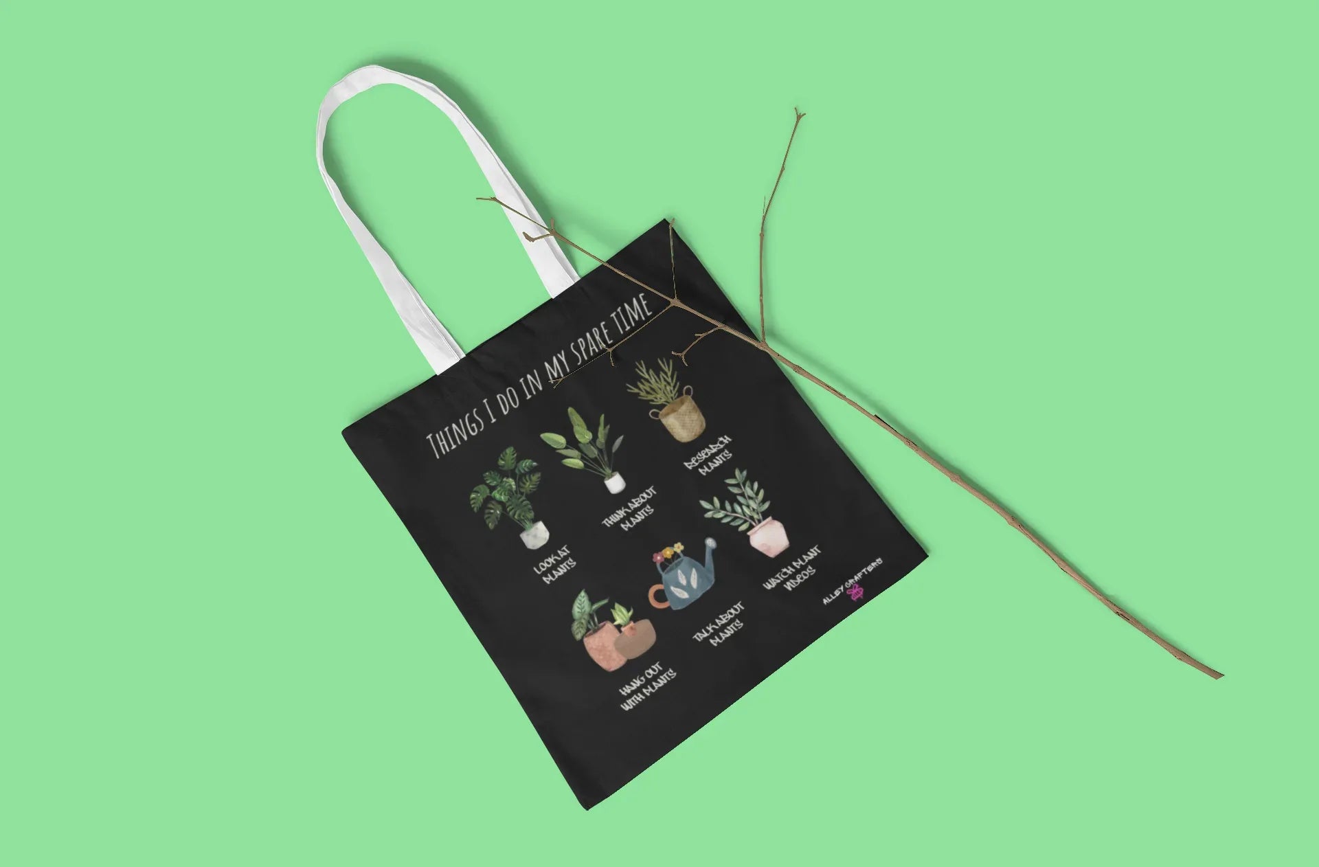Black plant tote bag with illustrated potted plants and text, long strap