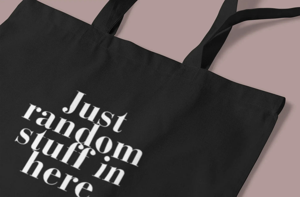 Black cotton tote bag with custom text "Just random stuff in here"