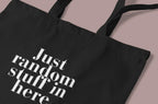 Black cotton tote bag with custom text "Just random stuff in here"