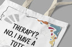 Close-up of white tote bag print with “THERAPY? NO, I HAVE A TOTE.” and doodles.