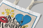 White tote bag close-up of blue heart and yellow star graphic with text